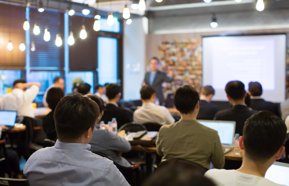 Audience,Listens,To,Lecturer,At,A,Conference,Meeting,Seminar,Training.